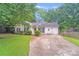 Charming single-story home with a well-maintained front yard, mature trees and an inviting driveway at 6216 Bandy Dr, Charlotte, NC 28227