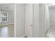 Hallway featuring modern vinyl floors, multiple doors and ample lighting at 6216 Bandy Dr, Charlotte, NC 28227