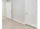 Neutral hallway with modern vinyl flooring and bright white doors at 6216 Bandy Dr, Charlotte, NC 28227