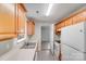 Bright kitchen featuring light wood cabinets, white appliances, and a stainless steel sink at 6216 Bandy Dr, Charlotte, NC 28227