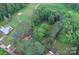 Beautiful aerial view of a partially wooded lot with mature trees near the golf course at 709 Sunset Dr, Salisbury, NC 28147