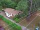 Aerial view shows the house surrounded by mature trees and lush greenery in a peaceful setting at 709 Sunset Dr, Salisbury, NC 28147
