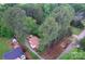 Aerial view of a home, nestled among trees, with a long driveway and outbuildings at 709 Sunset Dr, Salisbury, NC 28147