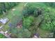 Aerial view showcasing the property's location surrounded by trees, with a nearby golf course at 709 Sunset Dr, Salisbury, NC 28147