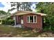 Lovely brick home with a manicured lawn, surrounded by mature trees, offering classic charm at 709 Sunset Dr, Salisbury, NC 28147