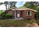 Charming brick ranch-style home with mature trees and landscaping creating an inviting curb appeal at 709 Sunset Dr, Salisbury, NC 28147