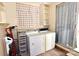 Bright laundry room features a washer, dryer, and built-in shelving for optimal storage at 709 Sunset Dr, Salisbury, NC 28147