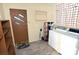 Functional laundry room with washer, dryer, storage shelves, and an exterior door at 709 Sunset Dr, Salisbury, NC 28147
