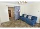 A cozy living room with a blue sofa and a connecting room visible at 709 Sunset Dr, Salisbury, NC 28147