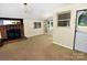 Cozy living area features a brick fireplace, neutral tones, natural light and open access to entry at 709 Sunset Dr, Salisbury, NC 28147