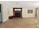 Spacious living room with fireplace, neutral walls, and windows, provides a comfortable atmosphere at 709 Sunset Dr, Salisbury, NC 28147