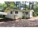 Rear exterior of home with light-colored siding, visible foundation, and a gravel driveway at 709 Sunset Dr, Salisbury, NC 28147