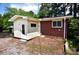 Back of house showcasing brick and siding, leading to a small bricked patio at 709 Sunset Dr, Salisbury, NC 28147
