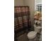 Cozy bathroom with stylish shower curtain and decorative floral arrangement on the toilet at 813 Latrobe Dr # 365, Iron Station, NC 28080