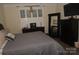 Bedroom with a ceiling fan, dresser with accessories, and large mirror at 813 Latrobe Dr # 365, Iron Station, NC 28080