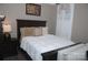Cozy bedroom featuring a dark wood bed frame and white bedding with bright natural light at 813 Latrobe Dr # 365, Iron Station, NC 28080