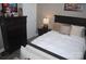 Comfortable bedroom features a dark wood bed frame, dresser and gray flooring at 813 Latrobe Dr # 365, Iron Station, NC 28080