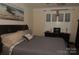 Charming bedroom with a boat painting, comfortable bed, and window with coverings at 813 Latrobe Dr # 365, Iron Station, NC 28080