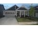 Charming home featuring a well-maintained front yard, covered porch, and a two-car attached garage at 813 Latrobe Dr # 365, Iron Station, NC 28080