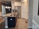 Granite countertop and stainless steel appliances in this kitchen are accented by modern lighting at 813 Latrobe Dr # 365, Iron Station, NC 28080