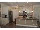Bright kitchen featuring white cabinets, stainless steel appliances, granite countertops, and a kitchen island with a sink at 813 Latrobe Dr # 365, Iron Station, NC 28080