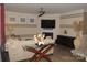 Inviting living room featuring a fireplace, modern ceiling fan, and neutral color palette at 813 Latrobe Dr # 365, Iron Station, NC 28080