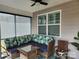 Cozy screened porch with plush cushions, wicker seating, and a bright, patterned rug at 813 Latrobe Dr # 365, Iron Station, NC 28080