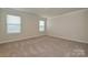 Bright and airy bedroom with neutral carpet and two large windows at 815 Blue Canyon Dr, York, SC 29745