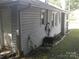 Side view of home showcasing exterior vinyl siding, brick foundation, and attached storage at 816 Parkwood Ave, Charlotte, NC 28205