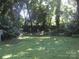 Spacious backyard featuring lush lawn and mature trees, offering privacy and shade at 816 Parkwood Ave, Charlotte, NC 28205