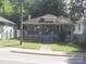 Quaint single-story home with inviting front porch with blue painted brick and wood railing at 816 Parkwood Ave, Charlotte, NC 28205