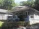 Charming single-story home with inviting covered porch and exterior painted in shades of blue at 816 Parkwood Ave, Charlotte, NC 28205