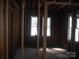 Interior view of a room with exposed wooden studs and natural light coming through windows at 816 Parkwood Ave, Charlotte, NC 28205