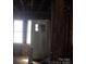 Interior view with exposed wall studs, a door, and natural light streaming in through windows at 816 Parkwood Ave, Charlotte, NC 28205