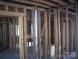 Interior view of a room with exposed wooden studs and a metal pipe visible at 816 Parkwood Ave, Charlotte, NC 28205
