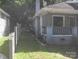 Side view of home with exterior vinyl siding, brick foundation, and covered porch at 816 Parkwood Ave, Charlotte, NC 28205