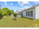 Backyard featuring a white home exterior, a grassy lawn, and a wooden fence with mature trees providing privacy at 8410 Darcy Hopkins Dr, Charlotte, NC 28277