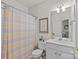 Clean bathroom with a single sink vanity, mirror, and a shower with a curtain at 8410 Darcy Hopkins Dr, Charlotte, NC 28277