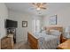 Cozy bedroom with a queen-sized bed, ceiling fan, and natural light from the window at 8410 Darcy Hopkins Dr, Charlotte, NC 28277