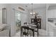 Cozy dining area with dark wood table, chandelier lighting, and access to the backyard through a sliding door at 8410 Darcy Hopkins Dr, Charlotte, NC 28277