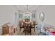 Dining room with a round table and chairs, lit by a chandelier, surrounded by boxes at 8410 Darcy Hopkins Dr, Charlotte, NC 28277