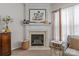 Elegant fireplace featuring a decorative mantel, tile surround, and a cozy ambiance with a view to the yard at 8410 Darcy Hopkins Dr, Charlotte, NC 28277