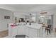 Bright kitchen featuring white cabinets and an open layout with an adjacent dining area and living room at 8410 Darcy Hopkins Dr, Charlotte, NC 28277