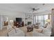 Comfortable living room featuring a fireplace, neutral tones, and plush seating with plenty of natural light at 8410 Darcy Hopkins Dr, Charlotte, NC 28277