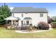 Home's backyard features a wooden deck, manicured lawn, and privacy landscaping at 9000 Petunia Ct, Gastonia, NC 28056