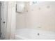 Bright bathroom with a white bathtub, tile walls, and neutral decor at 9000 Petunia Ct, Gastonia, NC 28056