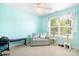 Bright bedroom with soft blue walls, ceiling fan, comfortable seating and a cat tree at 9000 Petunia Ct, Gastonia, NC 28056