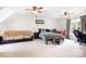 This is a spacious bedroom featuring carpet flooring, a bed, a couch, and two ceiling fans at 9000 Petunia Ct, Gastonia, NC 28056