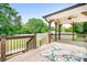 Covered wooden deck with ceiling fan, wooden railings and decorative outdoor rug at 9000 Petunia Ct, Gastonia, NC 28056