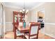 Formal dining room with hardwood floors and elegant chandelier, perfect for entertaining at 9000 Petunia Ct, Gastonia, NC 28056